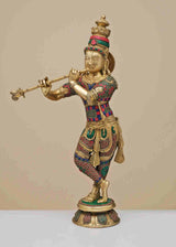 Brass Krishna statue playing flute, ornate circular patterns on chest and waist