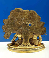 Brass Krishna and Radha statue base with tree trunk underside, decorative scroll border
