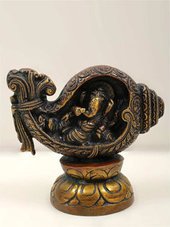Small brass Ganesha statue with conch (shankha), detailed relief carving
