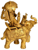 Brass Ganesha idol on elephant, side view with raised trunk and ornate seat