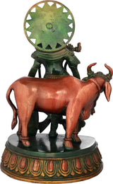 Brass Krishna statue with cow, 10 in—rear view showing halo wheel and cow