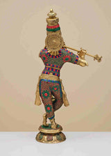 Brass Krishna fluting statue from behind, patterned dhoti and large circular back ornament