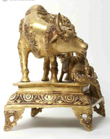 Brass Kamadhenu cow and calf figurine with Krishna on decorated base, 35 cm