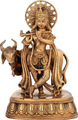 Handcrafted natural brass Krishna statue holding cow, 10 inches tall