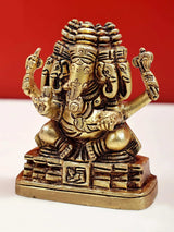 Small brass Panchamukhi Ganesha with four faces and ornate crown, seated on base