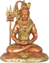 Gold brass Shiva idol seated cross-legged on tiger-skin base, trident beside