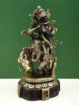 Venugopala black-and-brass statue of Krishna holding flute riding cow, 12 inch