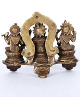 Back view of brass Ganesha-Lakshmi-Sarasvati triad statue on pedestal