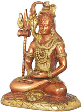 Gold brass Shiva statue, seated with hands in lap, detailed jewelry and raised trident