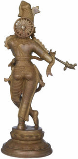 Brass Krishna statue side view, flute in hand, detailed crown and draped garments