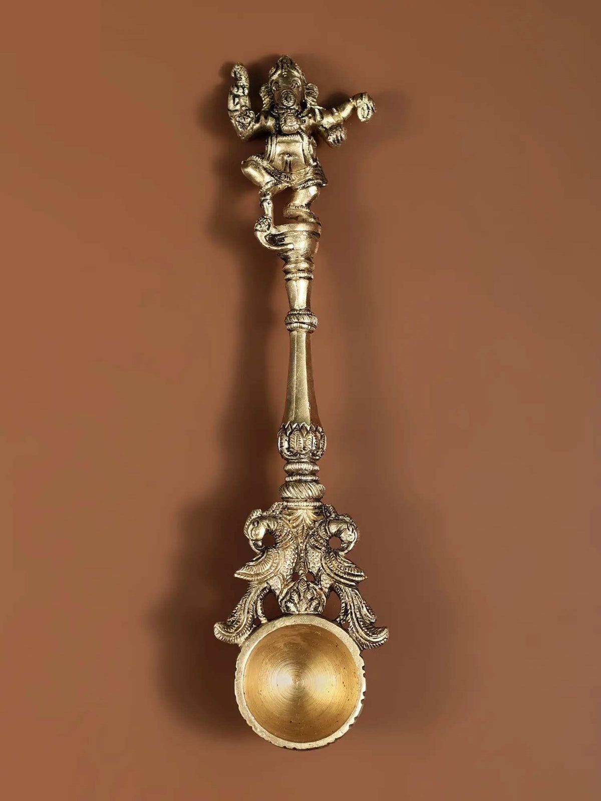 Ritual spoon with dancing Ganesha figurine, 22 cm; ornate brass-toned bowl