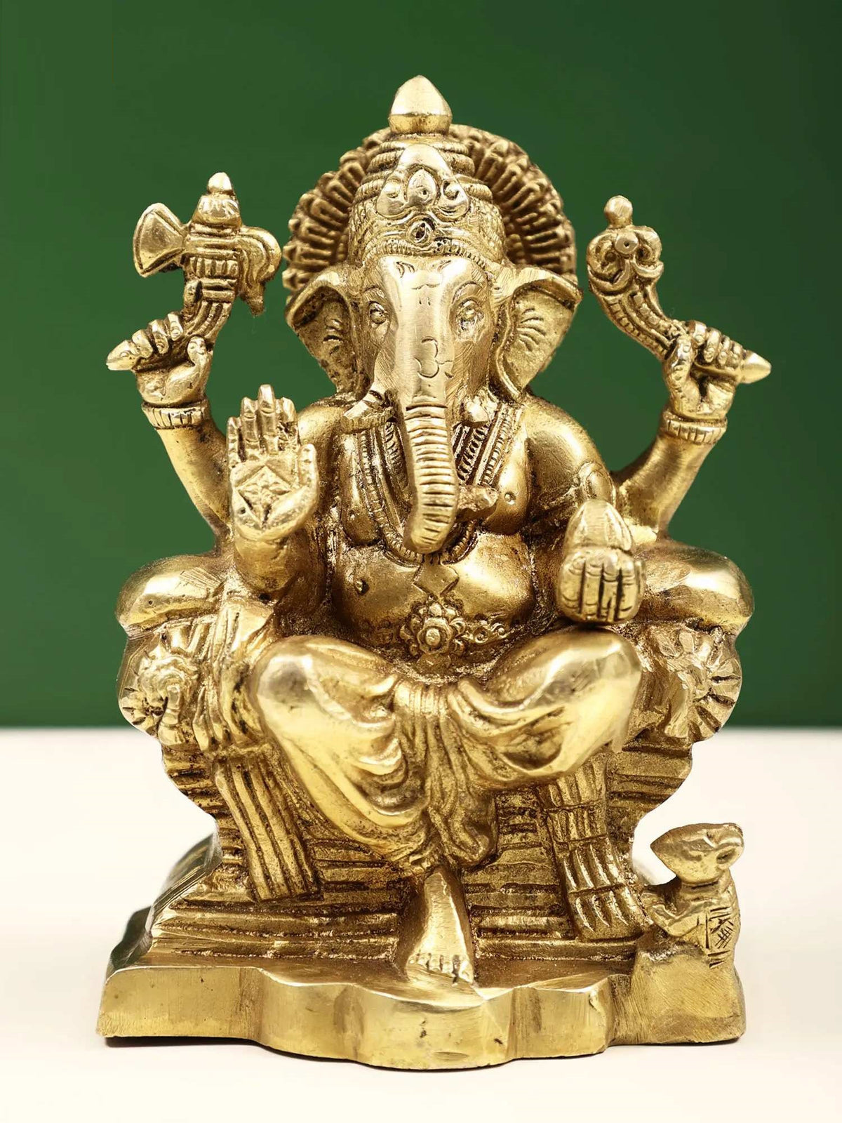 Brass Raja Ganpati statue, seated deity with raised hands and detailed crown, 5 in