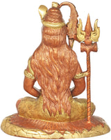Gold brass Shiva idol from behind, trident held beside seated figure on patterned base