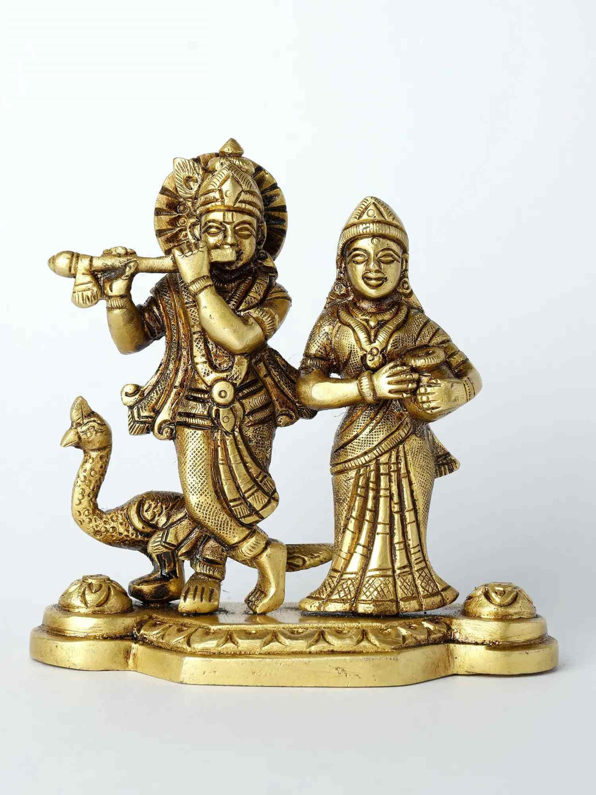 Brass Radha and Krishna statue with peacock motif base, two figures holding hands