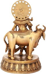 Handcrafted natural brass Krishna statue with cow, backside view, 10 inches