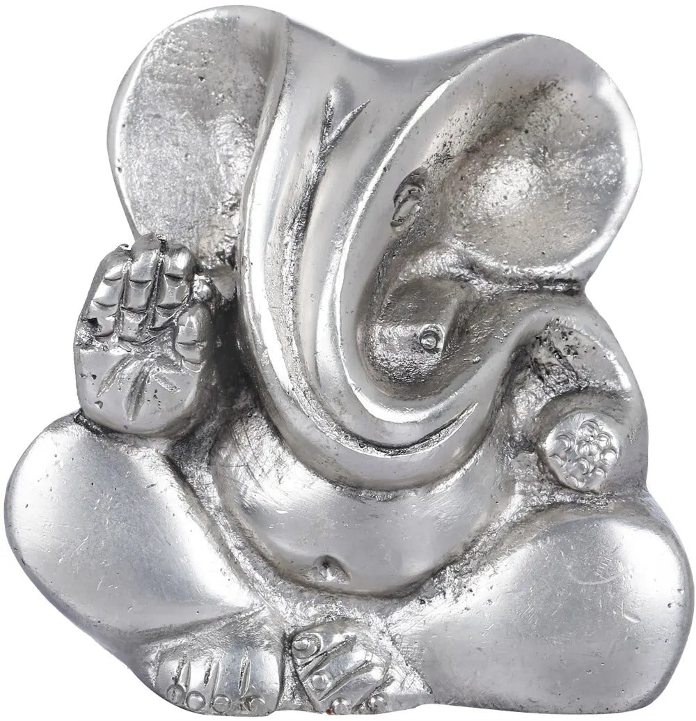 Small stylized Ganesha brass statue, seated with raised hand and trunk, metallic finish