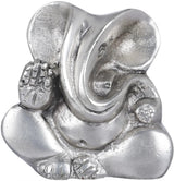 Small stylized Ganesha brass statue, seated with raised hand and trunk, metallic finish