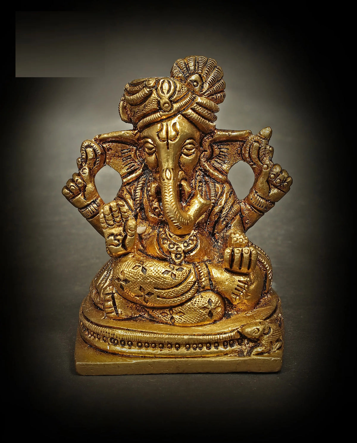 Small brass seated Lord Ganesha statue, turbaned, detailed ornaments (7.5 cm)