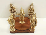 Brass Ganesha playing musical instruments on wooden base, side view, 7-inch
