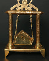 Brass jhoola with arched seat panel, deity peacock-sun top, hanging chains
