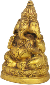 Gold-toned brass three-headed Ganesha statue with folded hands, close view