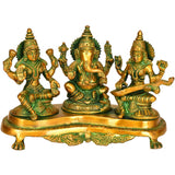 Brass Lakshmi-Ganesha-Saraswati figurines on ornate pedestal base
