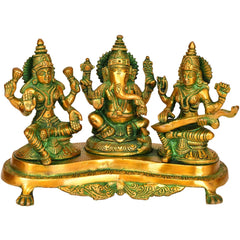 Brass Lakshmi-Ganesha-Saraswati figurines on ornate pedestal base