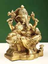 Brass Raja Ganpati idol close-up, elephant face, trunk, four arms, gold finish, 5 in