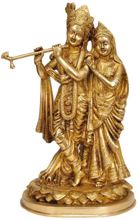 Handcrafted brass statue of Radha and Krishna, Radha behind as Krishna plays flute