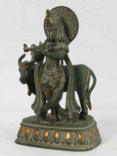 Handcrafted green patina Krishna brass statue riding cow, side view with halo