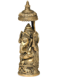 Small brass Ganesha idol with carved umbrella, 5 inches, side view, seated base