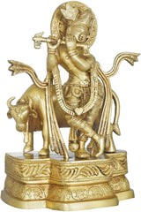 Brass Krishna flute statue, standing beside cow, ornate pedestal