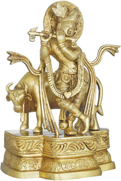 Brass Krishna flute statue, standing beside cow, ornate pedestal