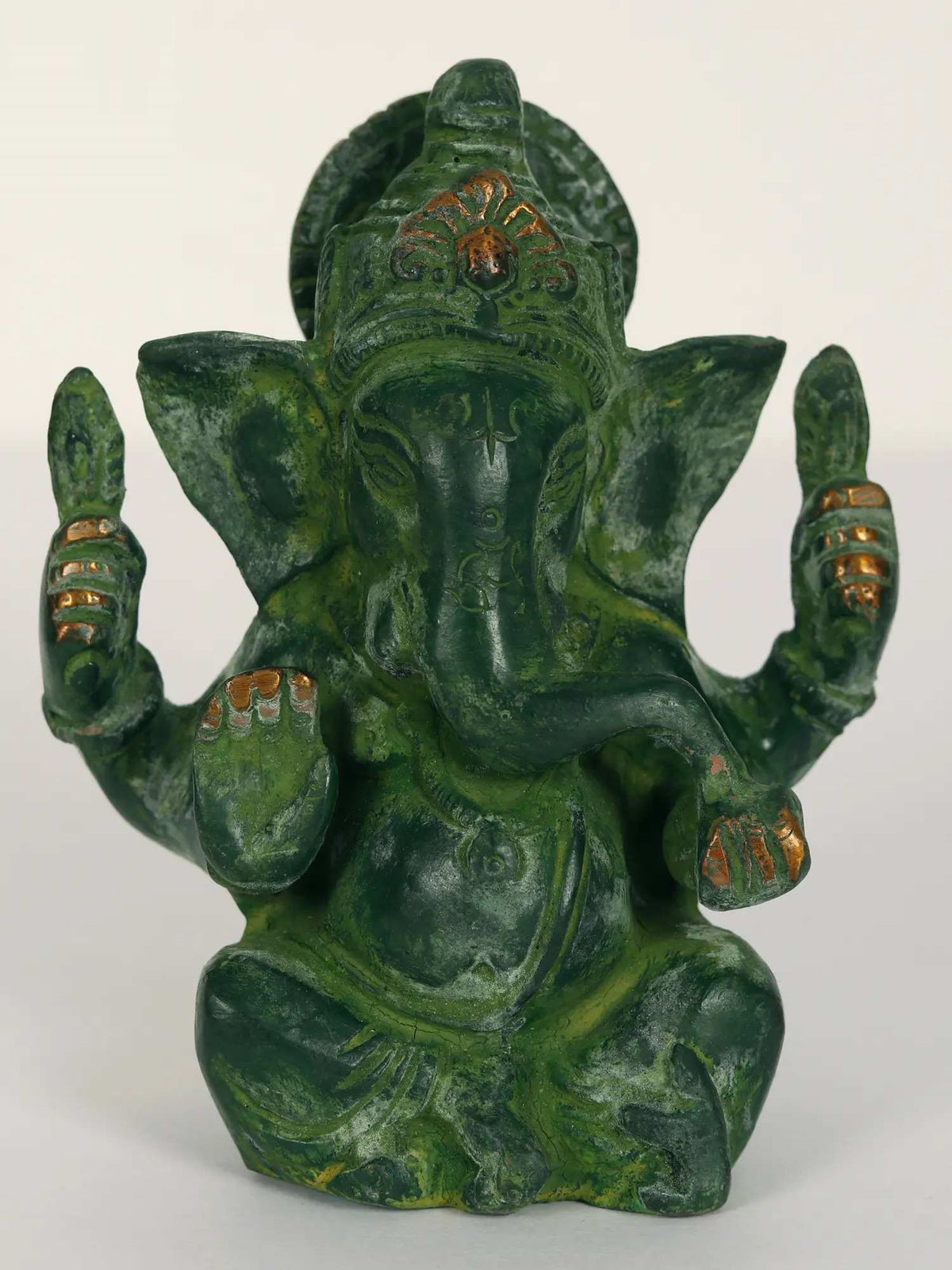 Brass Ganpati Maharaj figurine, seated with raised hands and painted green finish, front view