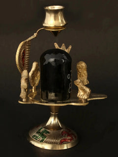 Black stone Shiva linga centerpiece with standing brass figures and ornate base, 6cm