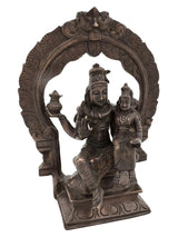 Antique brass Shiva and Parvati idol seated on ornate throne with arch detailing