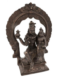 Antique brass Shiva and Parvati idol seated on ornate throne with arch detailing