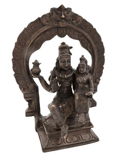 Antique brass Shiva and Parvati idol seated on ornate throne with arch detailing