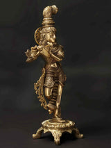 Standing brass Krishna statue holding flute, ornate crown and jewelry, on base