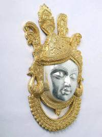 Silver face with closed-eye look on Shrinathji wall hanging, gold ornate crown