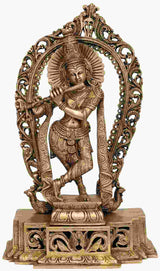 Brass statue of Shri Krishna with flute, ornate arch base and engraved detailing