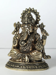 Brass Ganesha statue with four arms, laddu held, ornate jewelry, seated