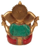 Back view brass Ganesha statue, teal torso and red skirt with gold trim