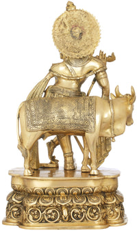 Brass sculpture side view: Krishna playing flute on cow, engraved patterns and drapery