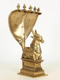 Brass Nandi seated on base with five-headed Sheshnag canopy, 29 cm