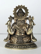 Brass Ganesha statue, four arms holding laddu, seated, ornate halo and base