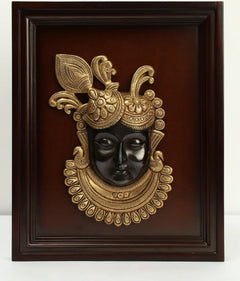 Brass Shrinath Ji face wall hanging in dark wooden frame, ornate crown details