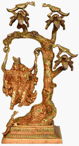 Brass Radha-Krishna statue on swing atop ornate tree base, 16 inches