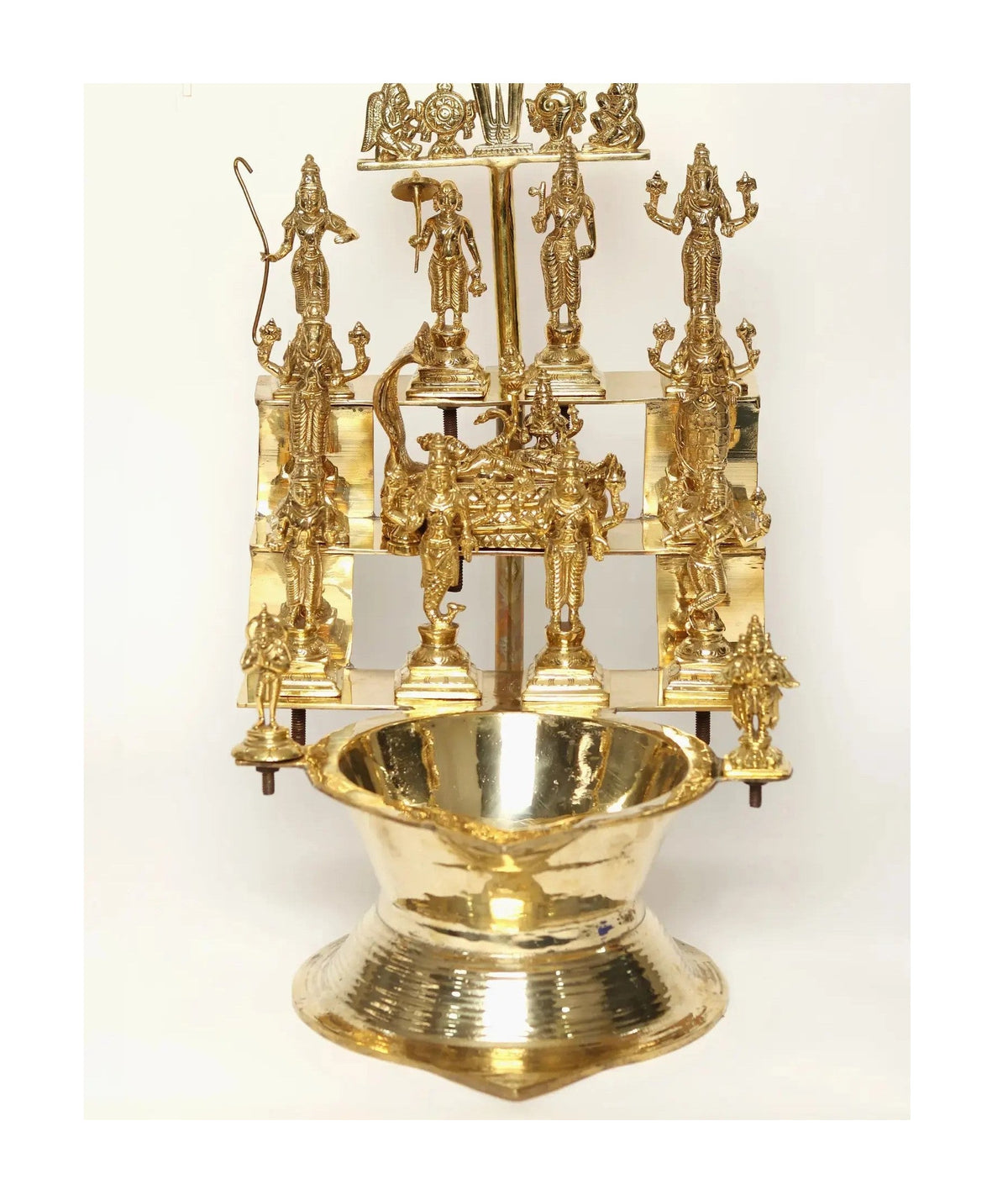 Brass oil lamp with Vishnu Dashavatar figures and central oil bowl, 19 inches