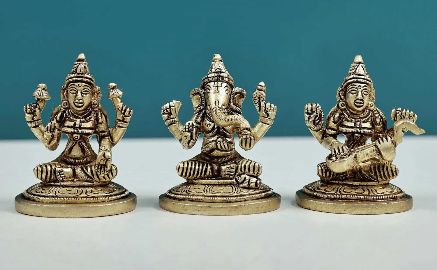 Set of three small brass statues of Ganesha, Lakshmi, and Saraswati 2 inches